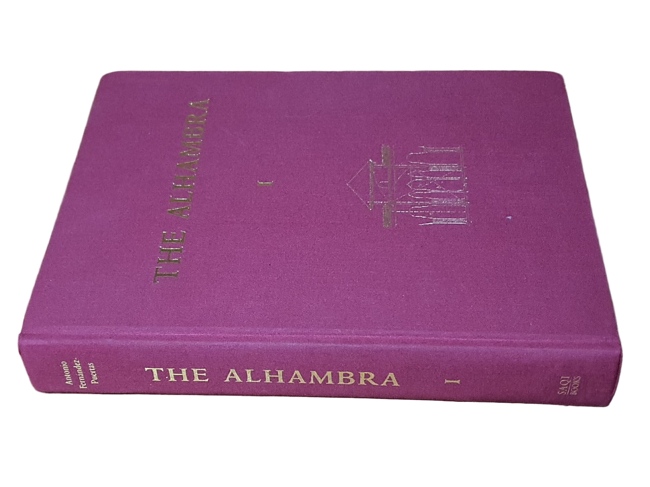 Purple book titled 'The Alhambra' on a wooden surface