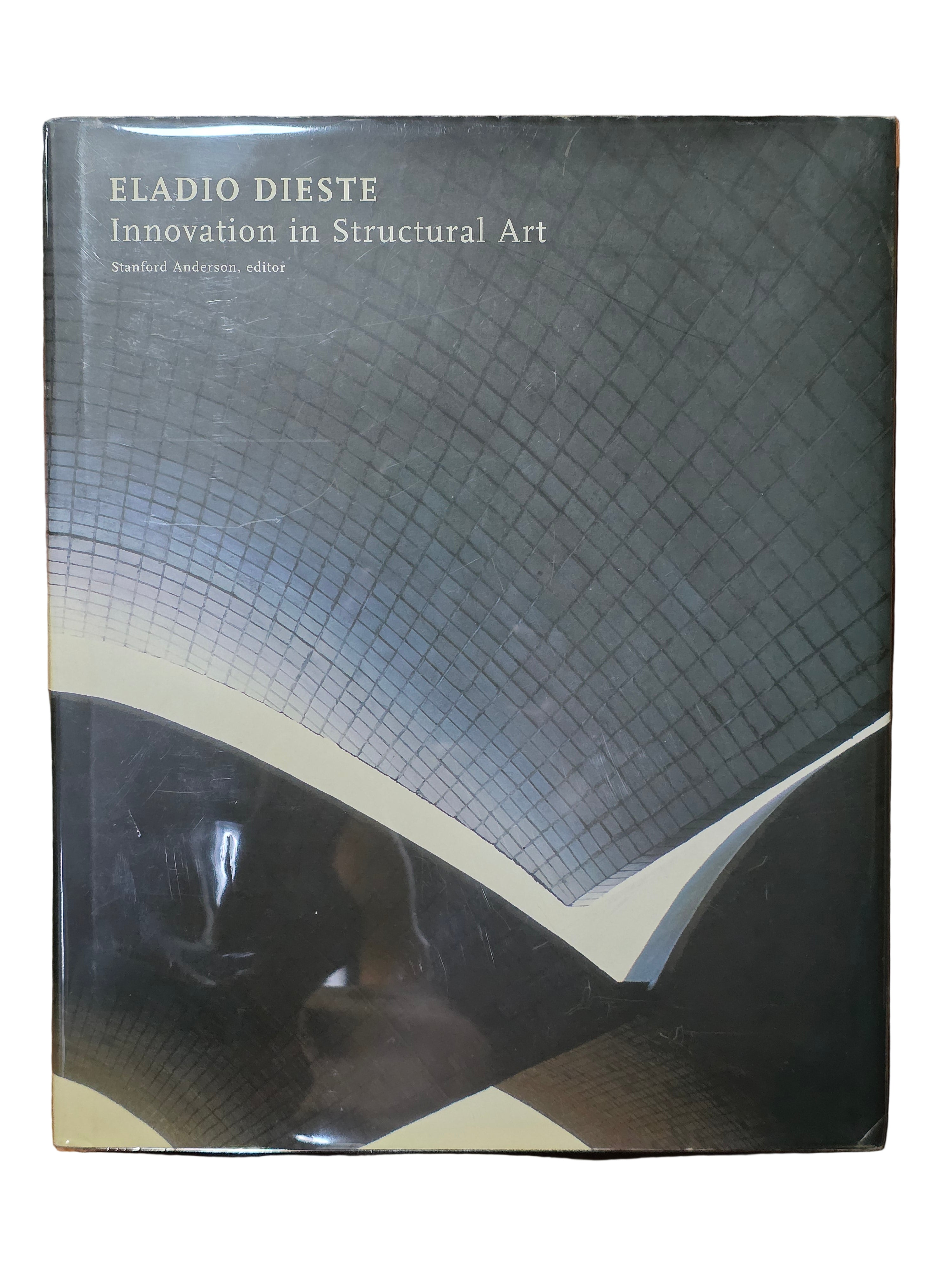 Book titled 'Eladio Dieste: Innovation in Structural Art' on a wooden surface