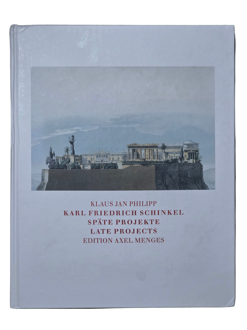 Book with cover featuring a photograph of classical architecture on a wooden surface